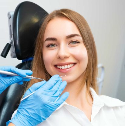portrait-of-smiling-woman-sitting-in-dental
